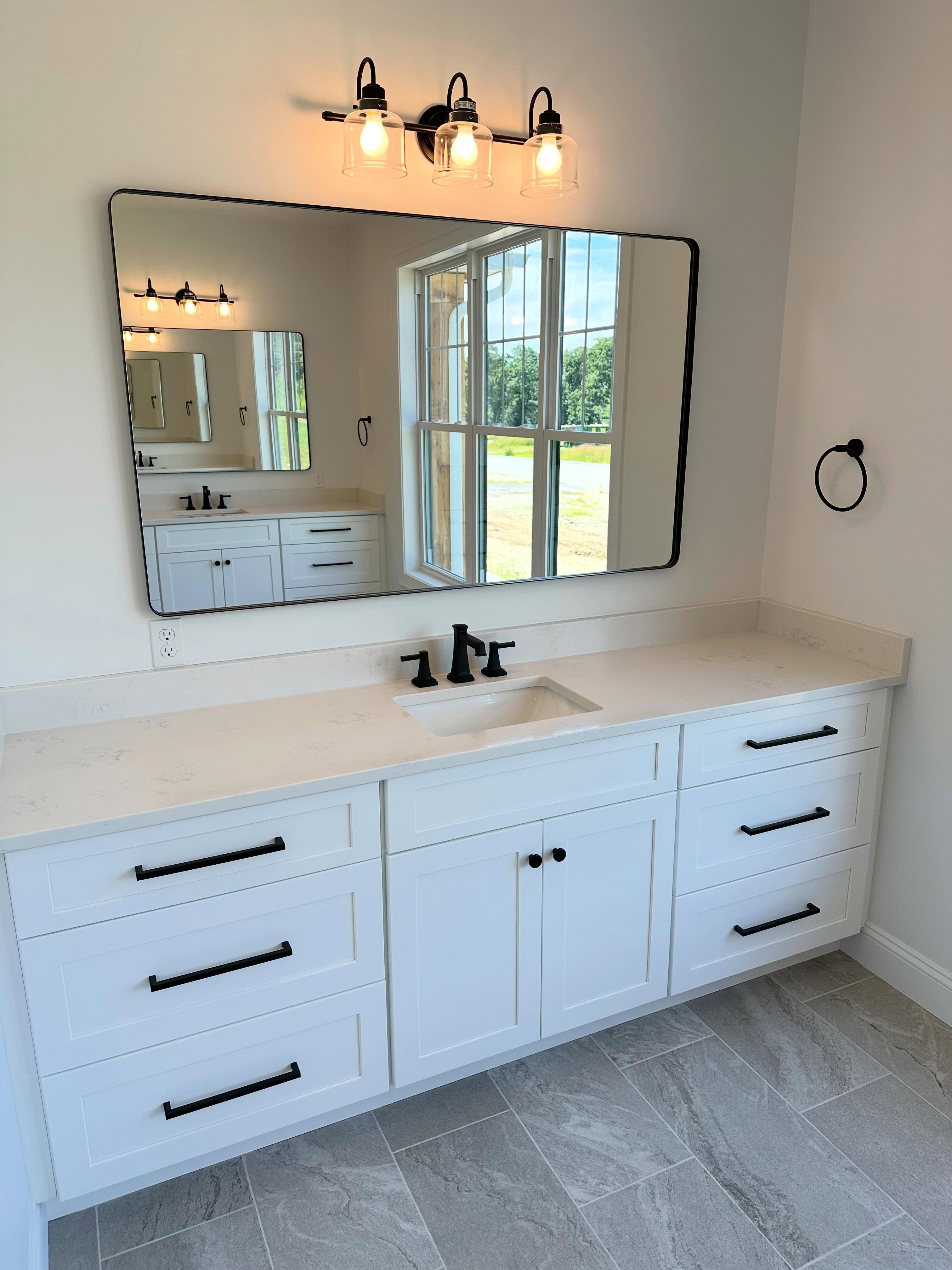 Vanity with large mirror and window light