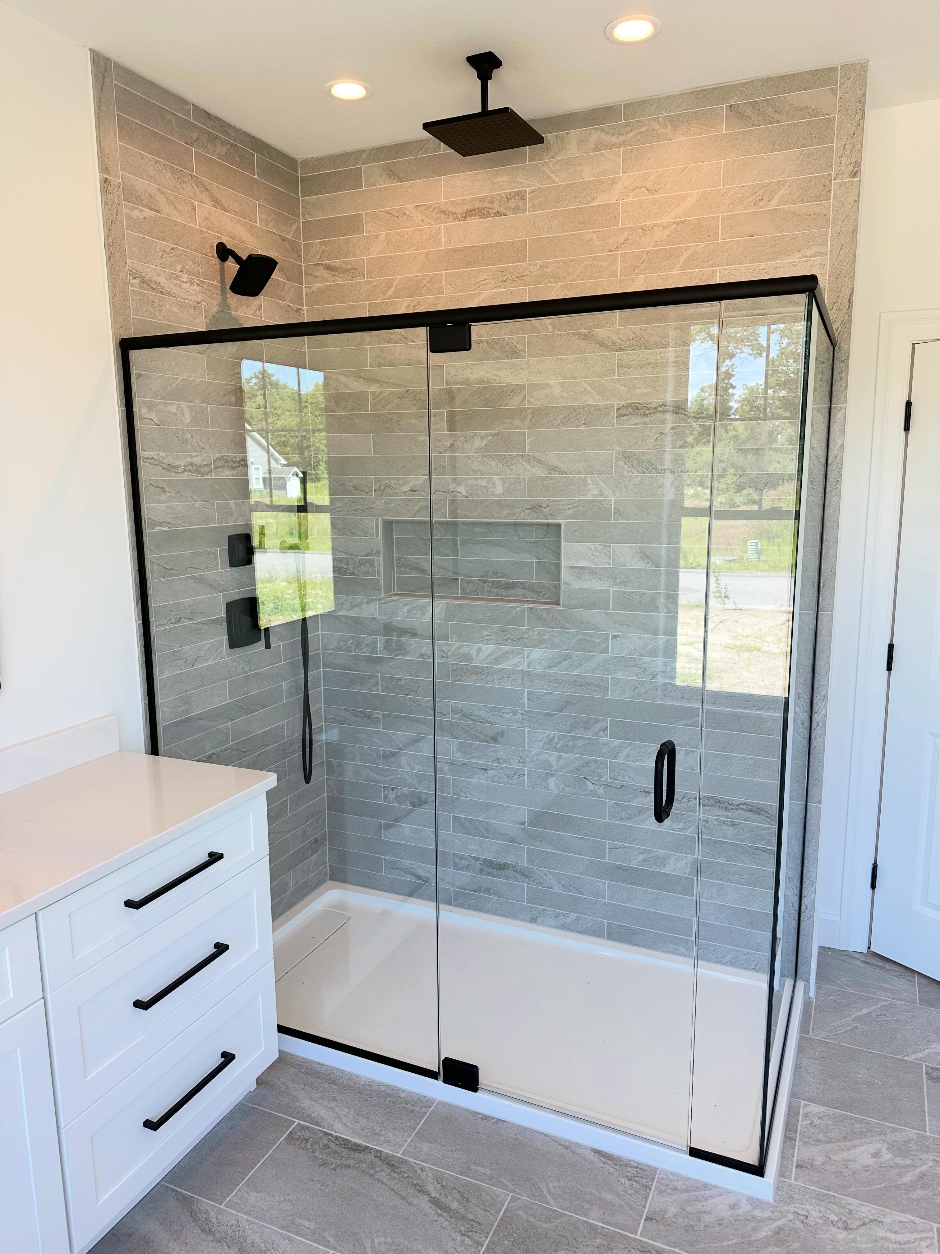 Walk-in tiled shower with frameless glass