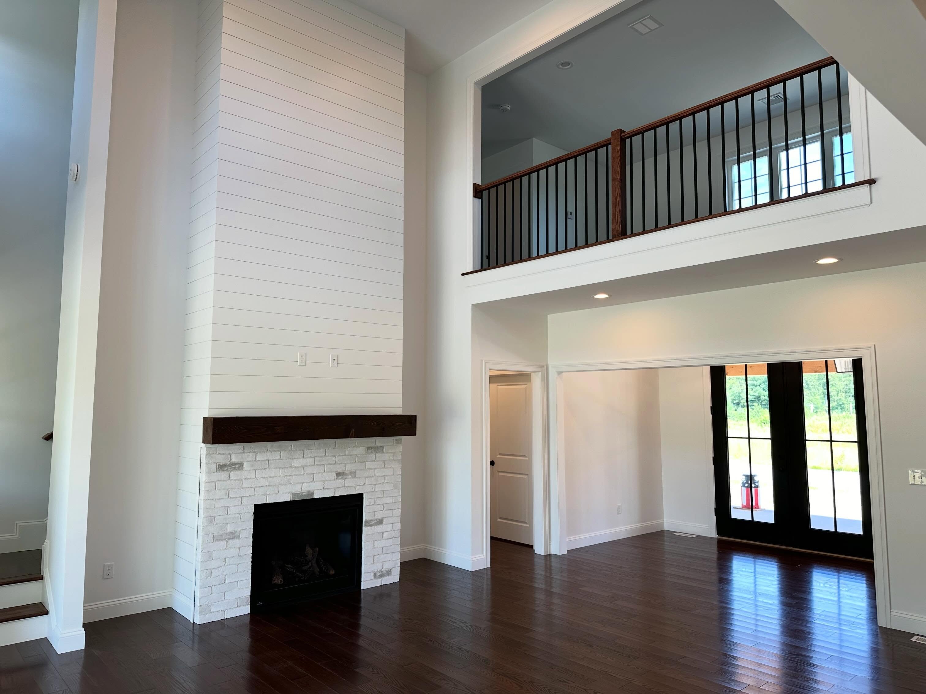 Finished white brick fireplace with loft above