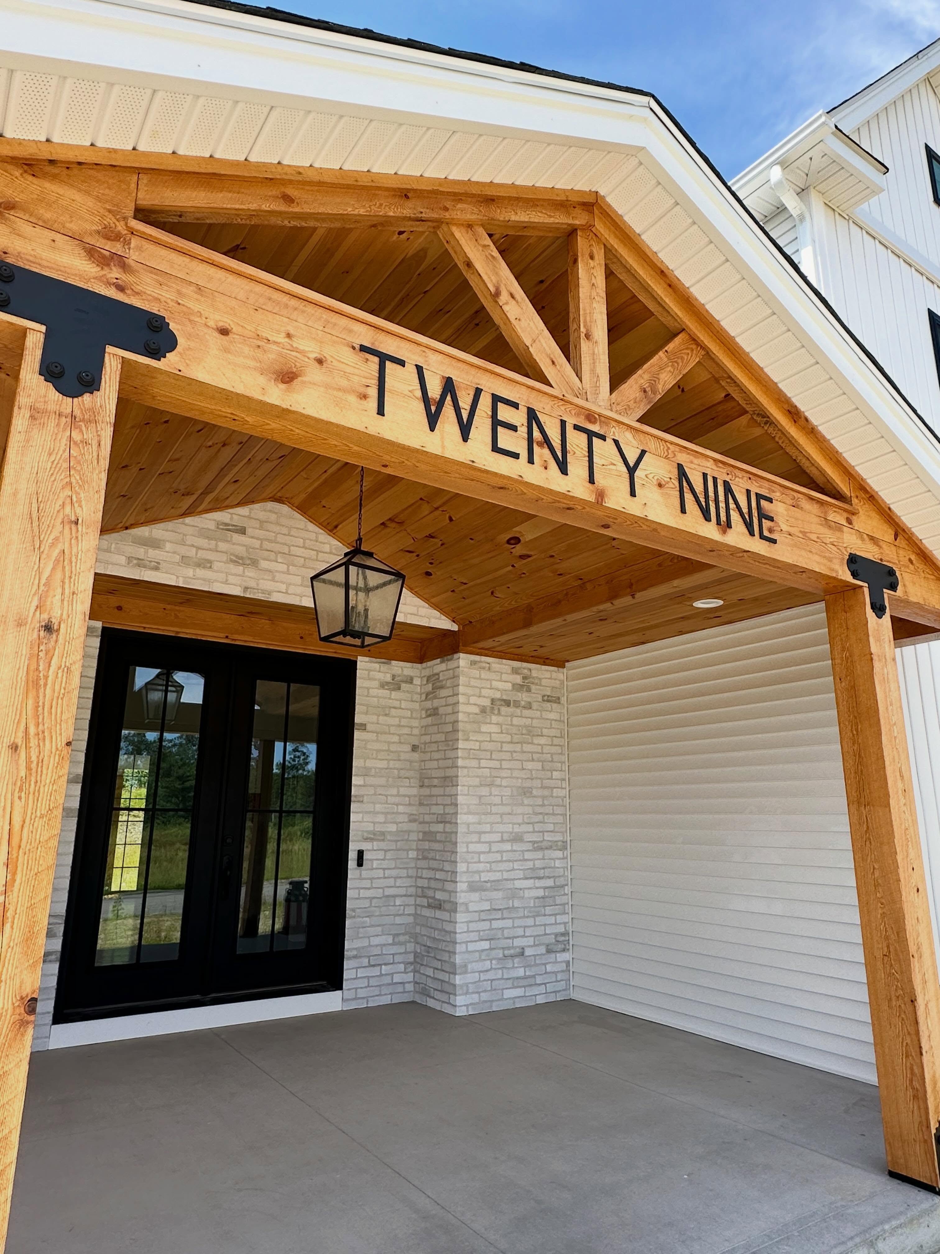 Timber-frame entry with Twenty Nine carved into the beam