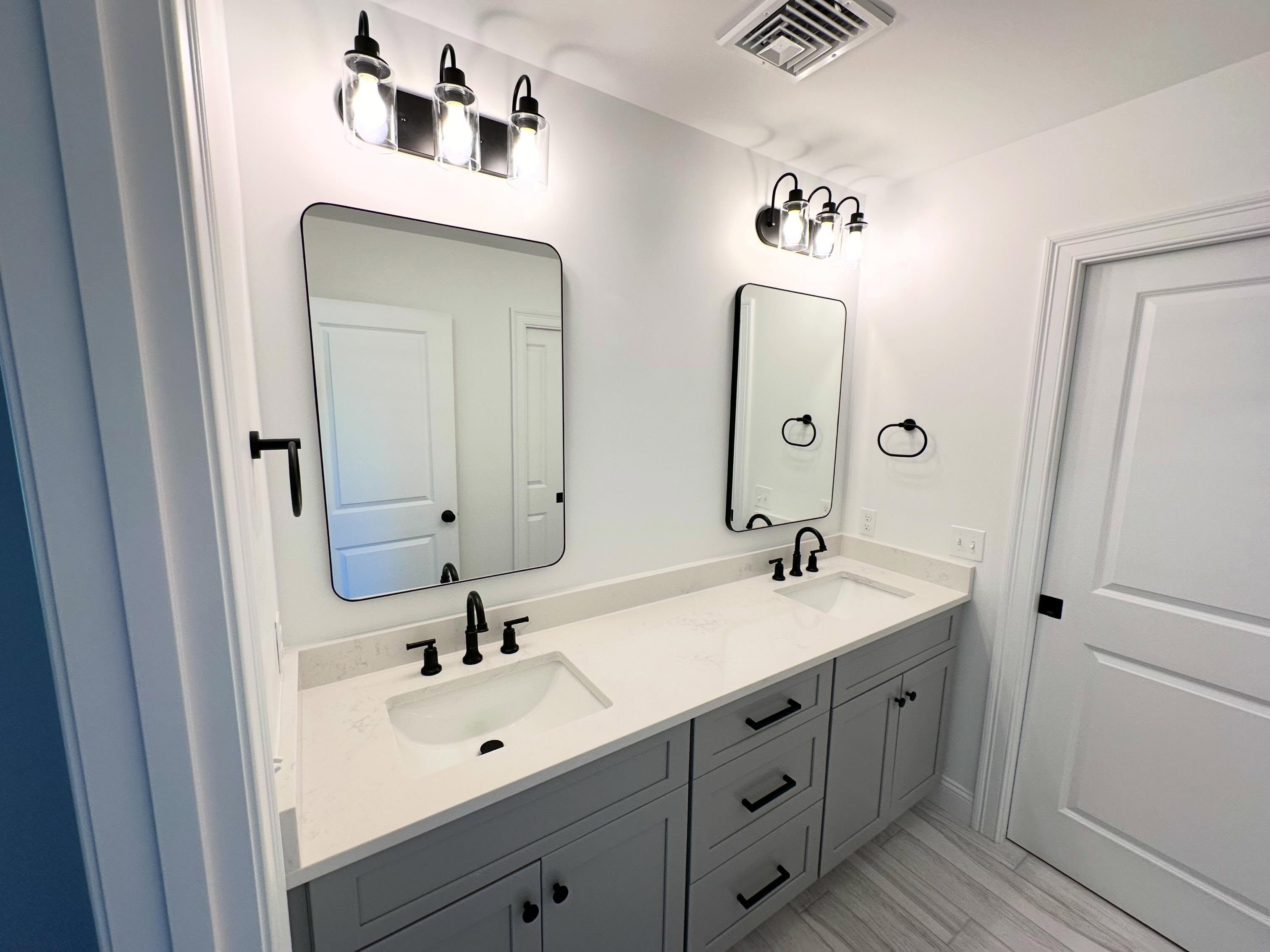 Gray double vanity with black fixtures