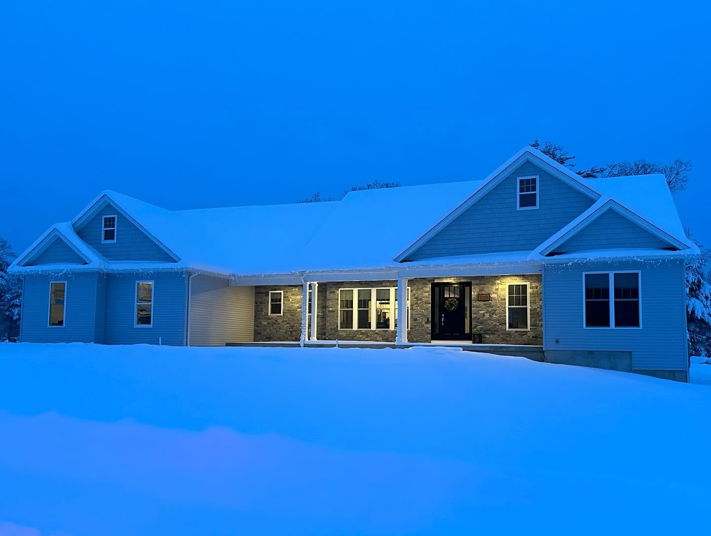 Finished custom ranch at dusk in snow